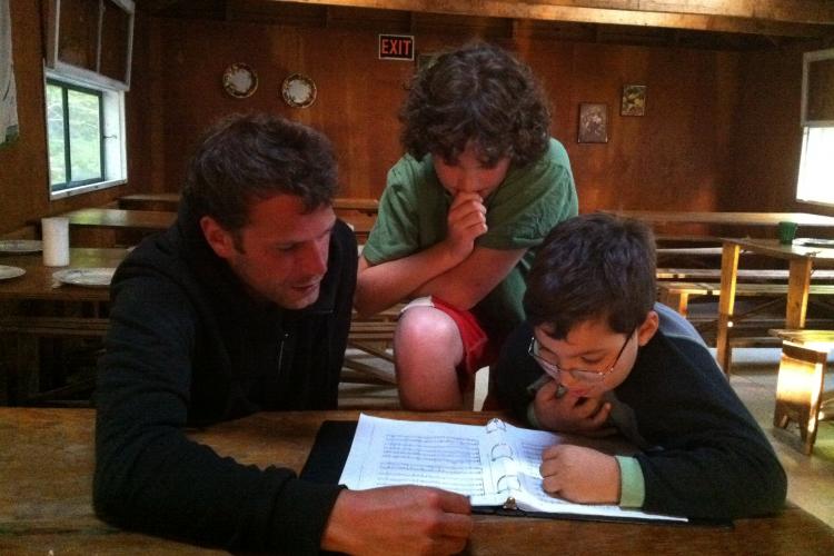 Nick helps the boys study a piece.