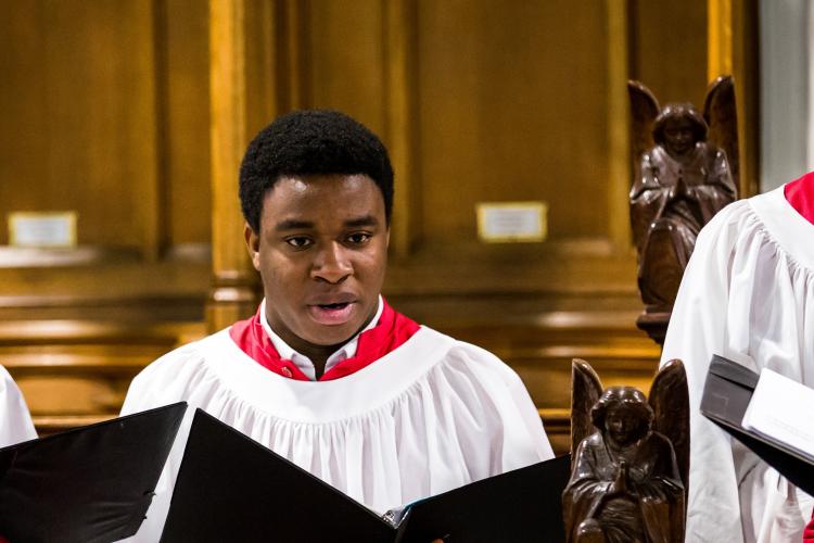 Young adult male chorister singing during Evensong service